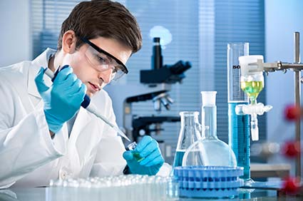 man in white coat conducting a blood test